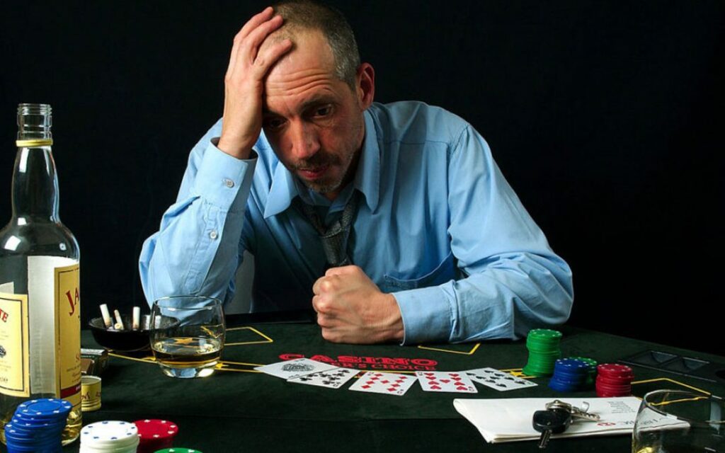 Problem Gambling - How to Know the Symptoms, Diagnosis, Treatment 3 Problem gambling addict sadly holding head after losing the game