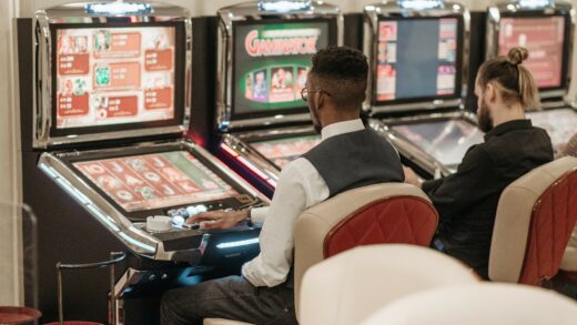 A black man sitting on a chair playing gambling games